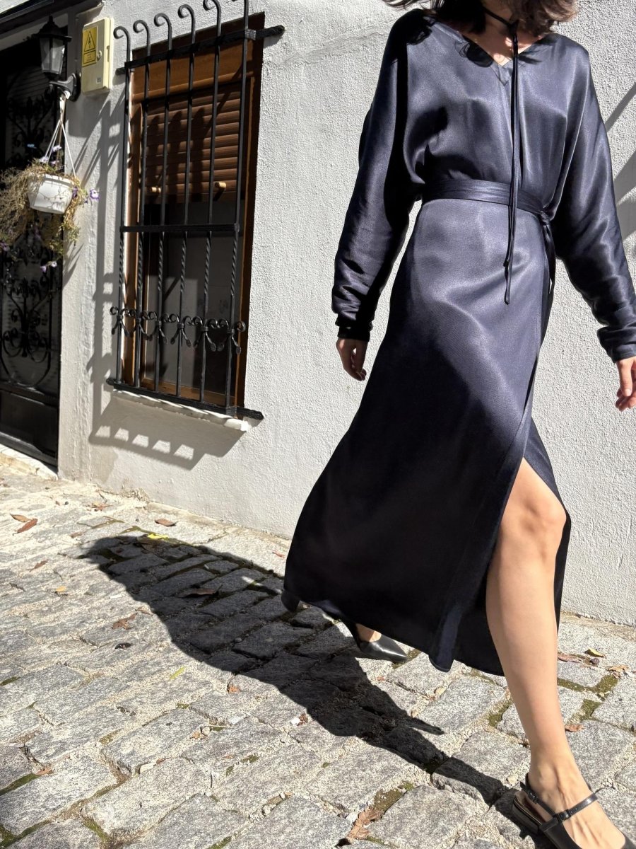 Model walking in the navy dress, the front slit showing her leg