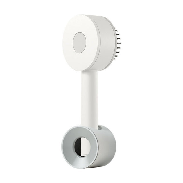 White hairbrush standing in a grey ring-shaped holder