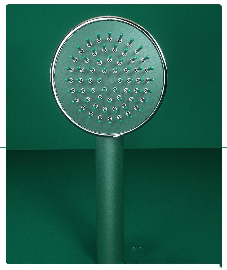 Front close-up of the round green brush head with ball-tipped pins