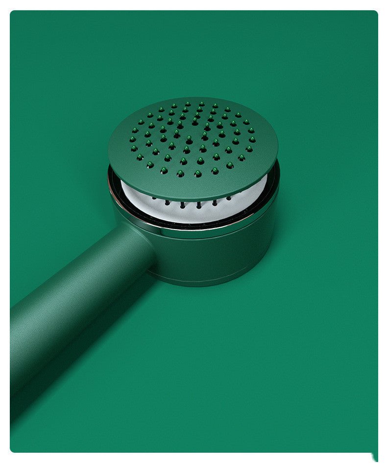 Close-up of the green brush head lying down, with the pins retracted into the cushion