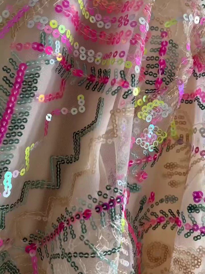 Close-up of the mesh with fuchsia, green, gold and clear sequins in zigzag lines
