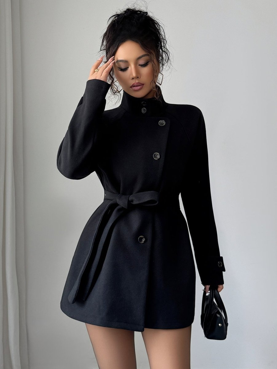 Black coat with stand collar and raglan sleeves, belt tied at the waist