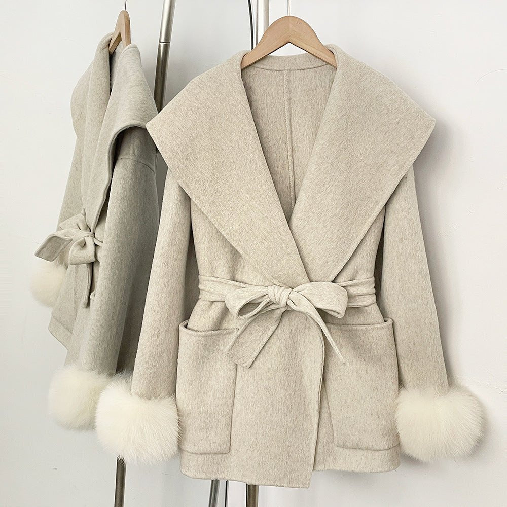 Short wrap coat with wide collar and fluffy cuffs in beige, front view on hanger