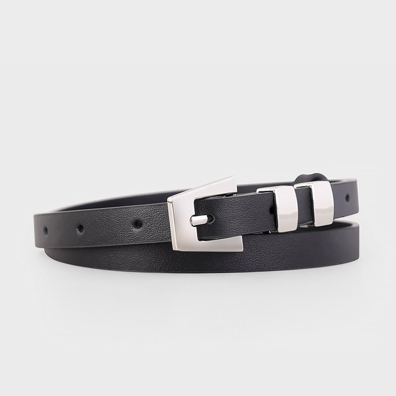 Black skinny leather belt with polished silver buckle on a mannequin - Premium cowhide accessory