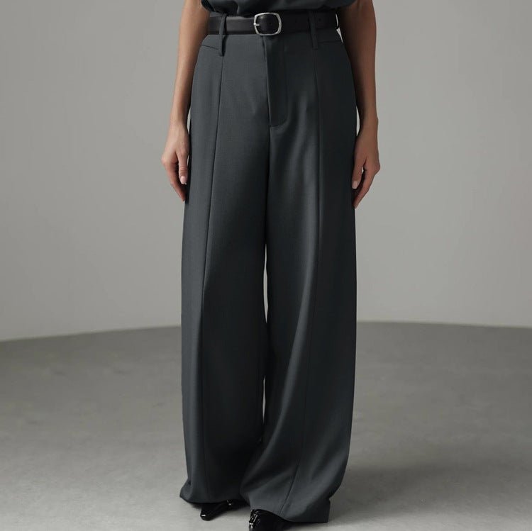 Wide-leg grey trousers with a pressed crease, hem reaching the floor