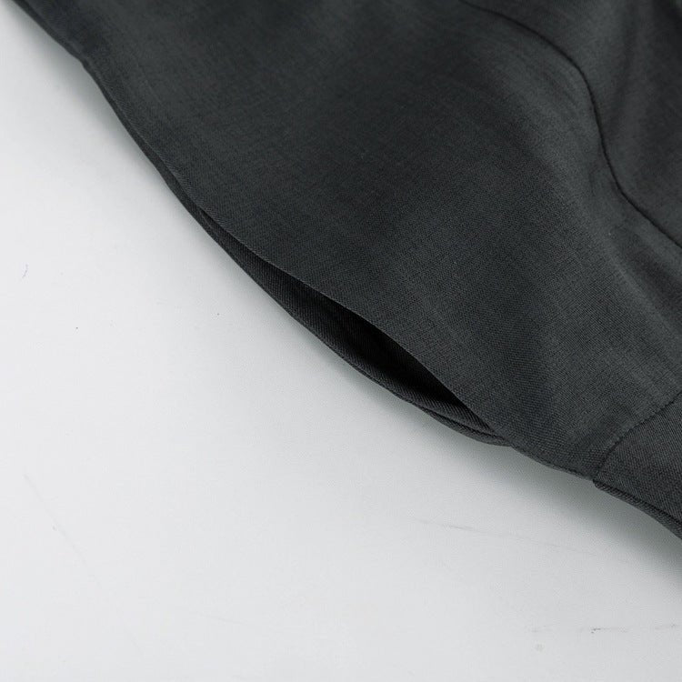 Side pocket opening on the grey trousers