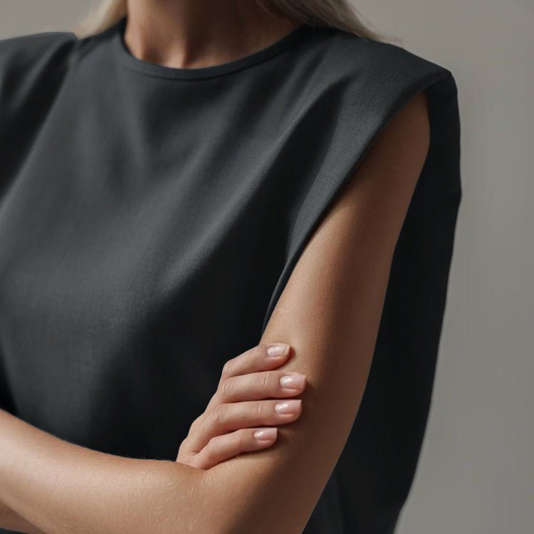 Round neckline and extended shoulder of the grey sleeveless top