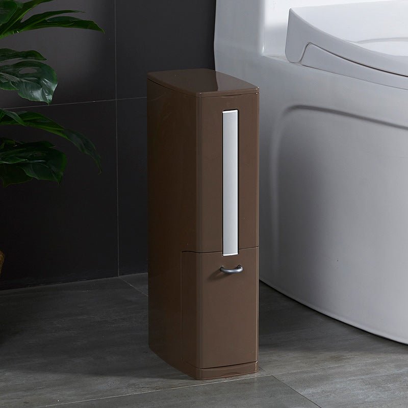 Brown slim bathroom bin with built-in toilet brush standing next to a toilet