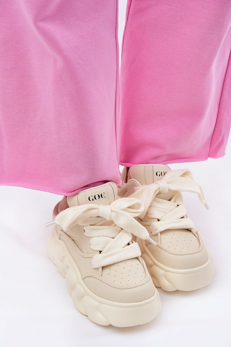 Women wearing beige sport shoes in urban setting