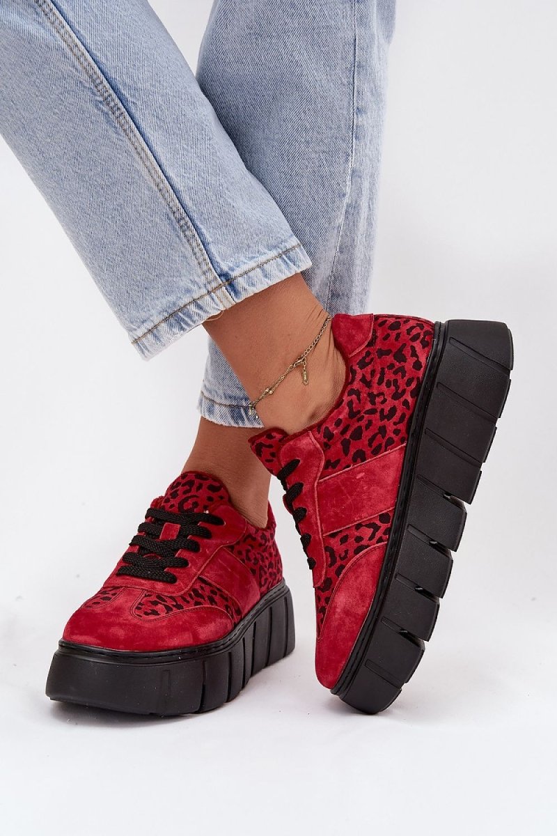 Woman wearing leopard print sneakers in urban setting
