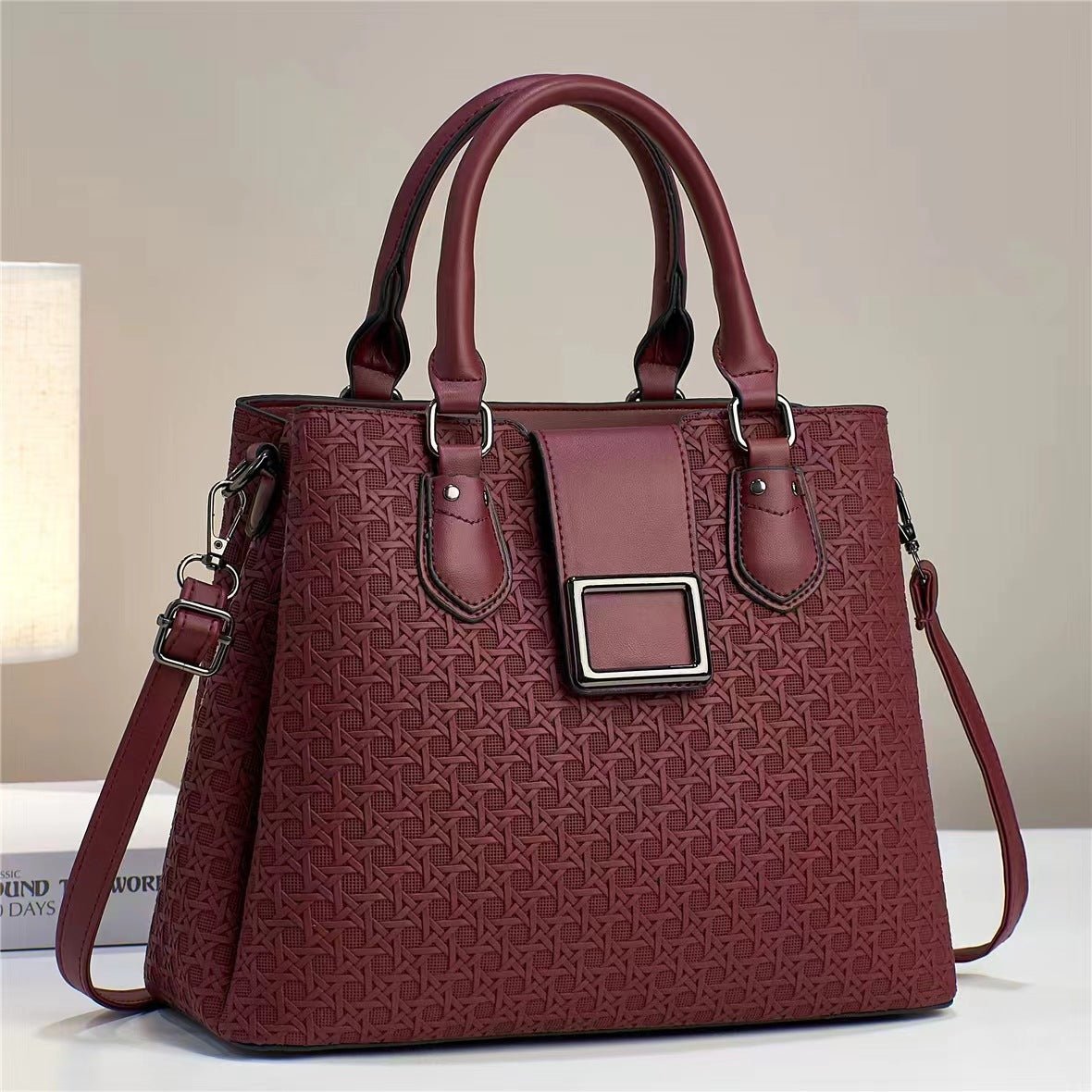 Wine red embossed handbag with silver-coloured rings