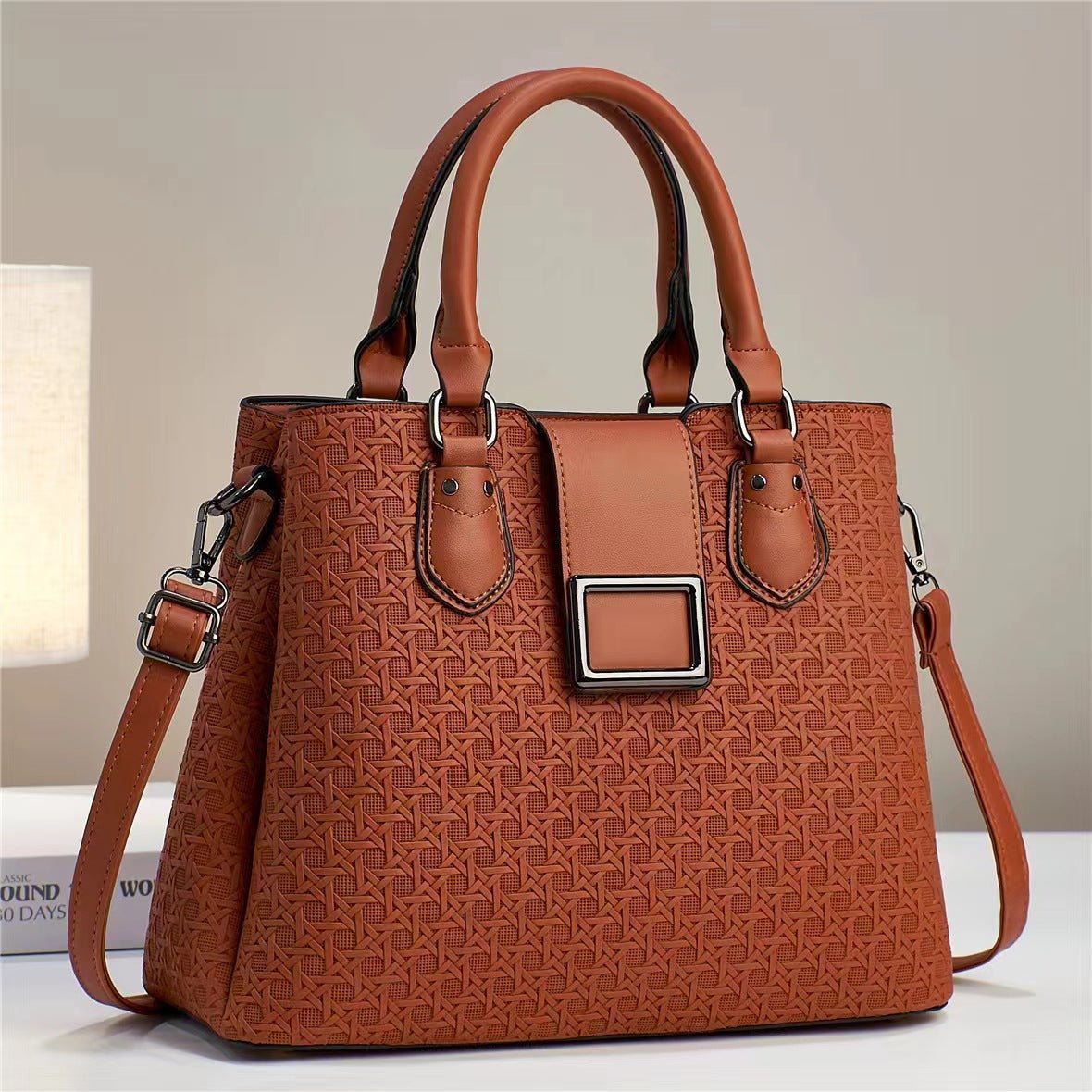 Rust-toned brown embossed handbag with detachable strap