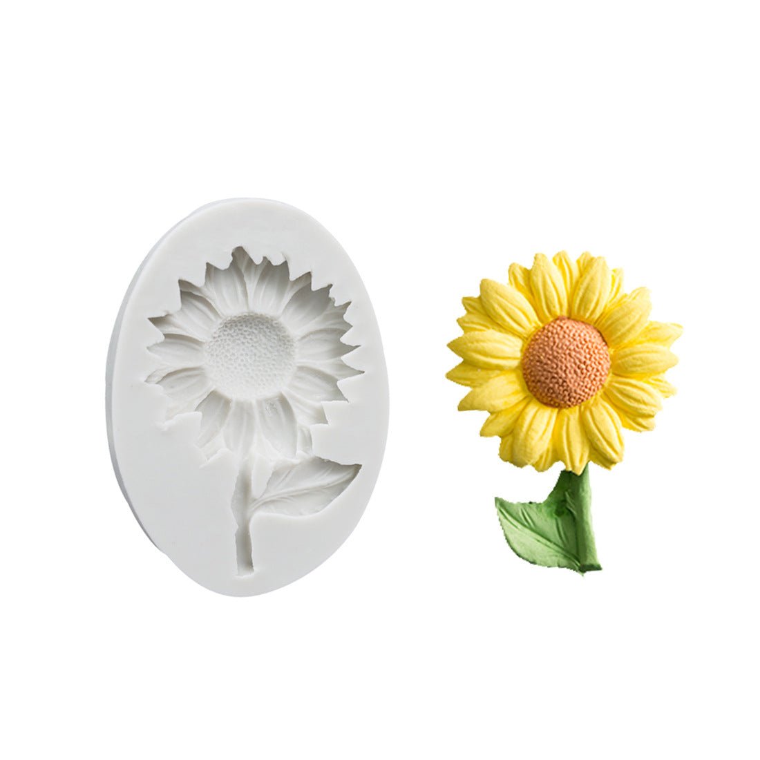 White oval silicone sunflower mould next to a finished yellow fondant sunflower with green leaf
