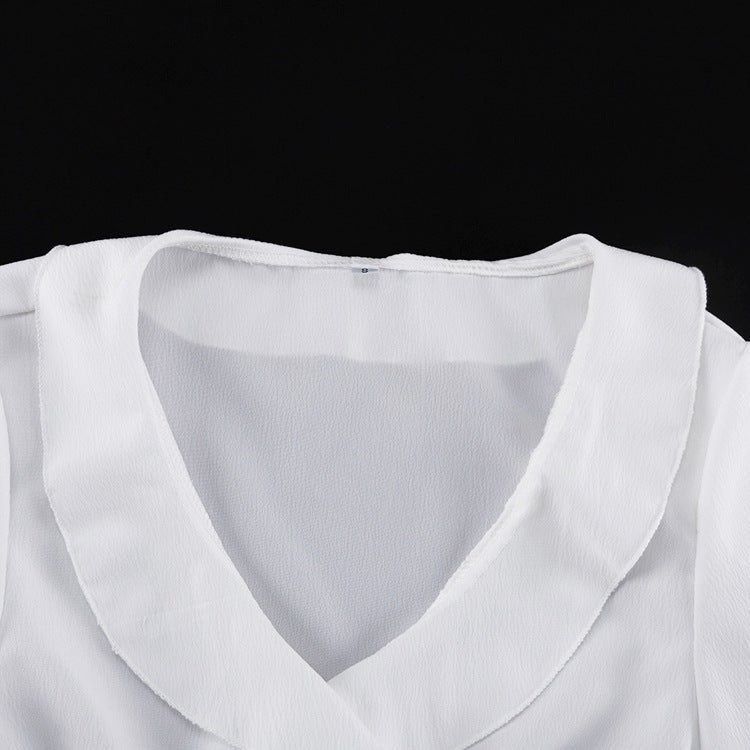 V-neckline of the top with its turned collar edge