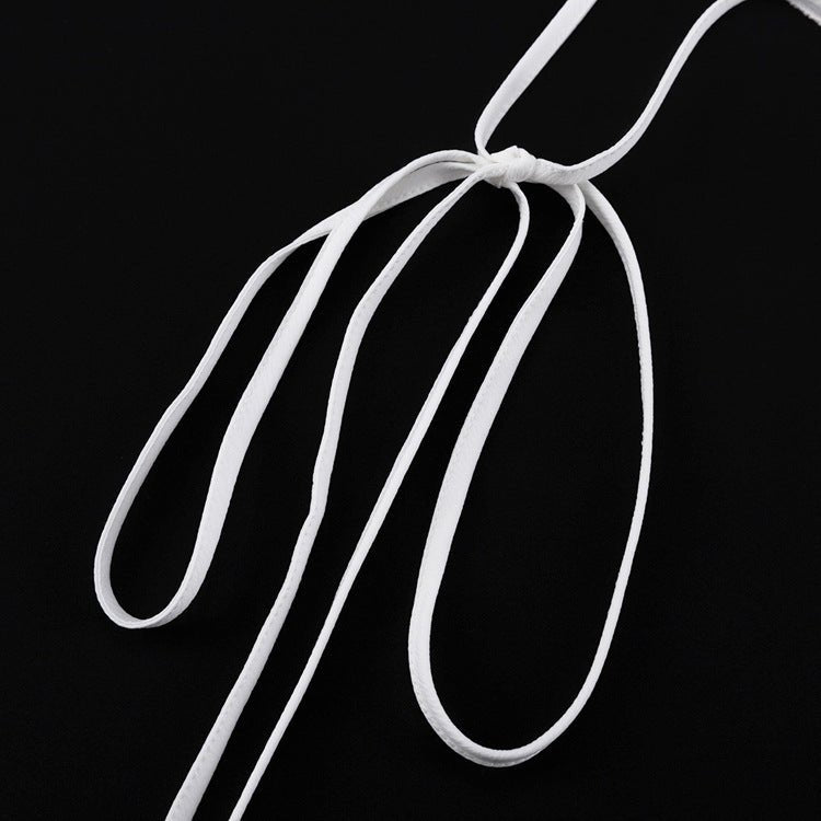 Thin white waist ties knotted in a bow