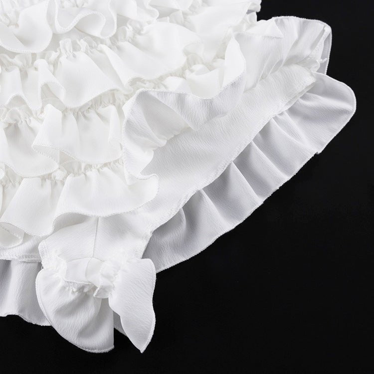Ruffle tiers of the skirt and a small bow detail