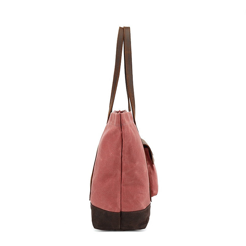 Rose rode waxed canvas tas, zijaanzicht met diepte en platte leren bodem