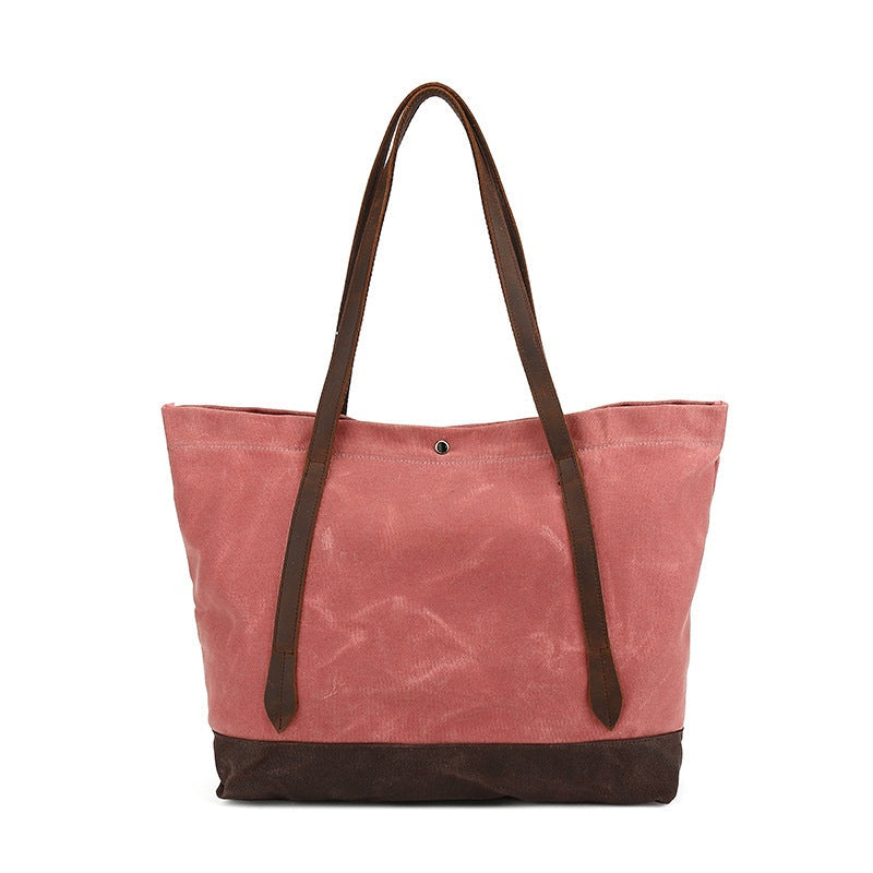 Rose rode waxed canvas tas, recht vooraanzicht met twee lange leren hengsels