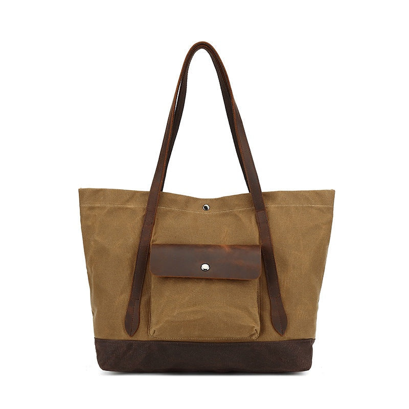 Khaki waxed canvas tas met bruine leren details, vooraanzicht