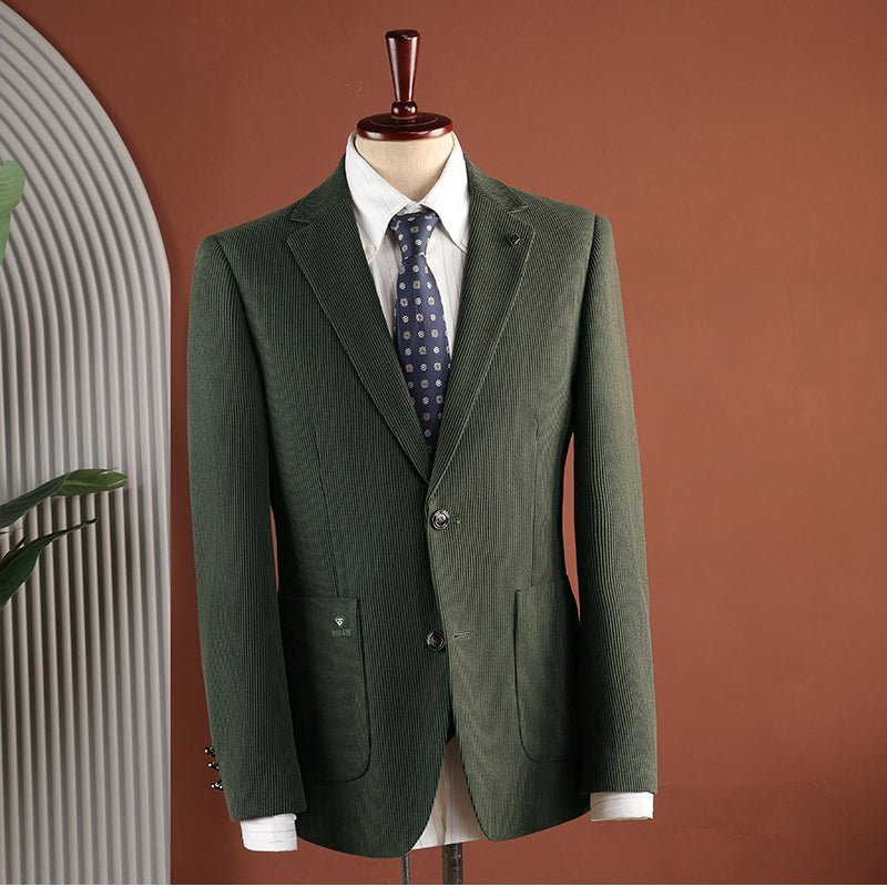 Green blazer on a mannequin against a terracotta wall