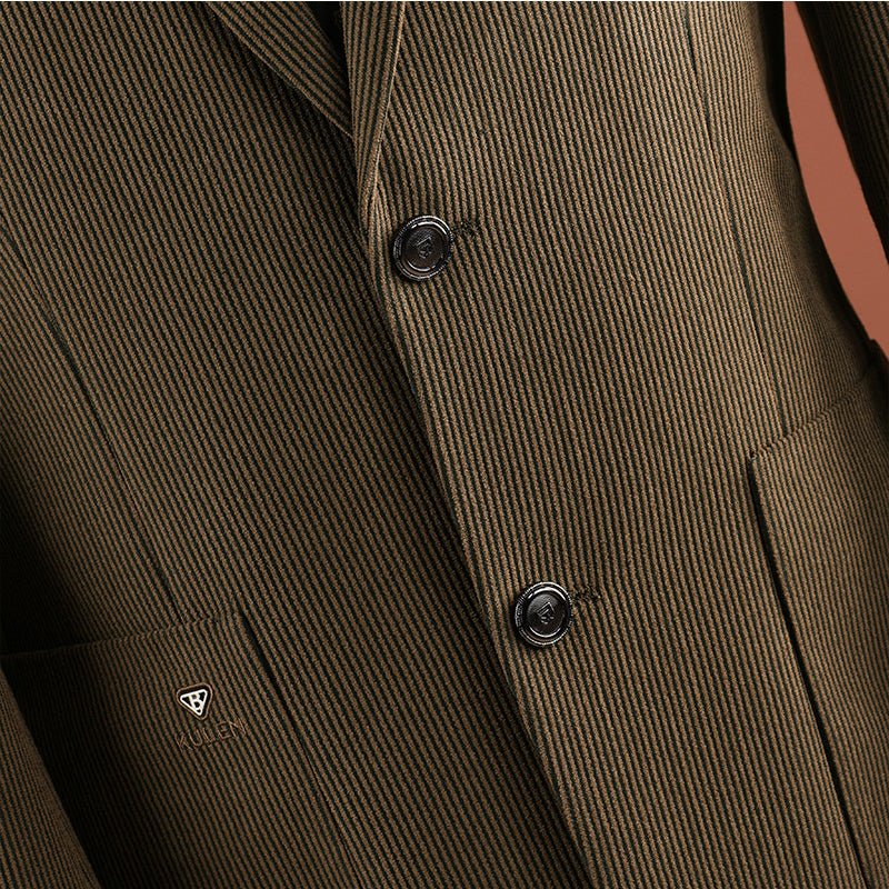 Close-up of the coffee brown ribbed fabric, two front buttons and a small emblem on the pocket