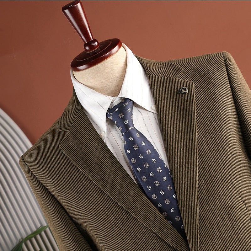 Close-up of the coffee brown blazer's collar and lapel with a small pin