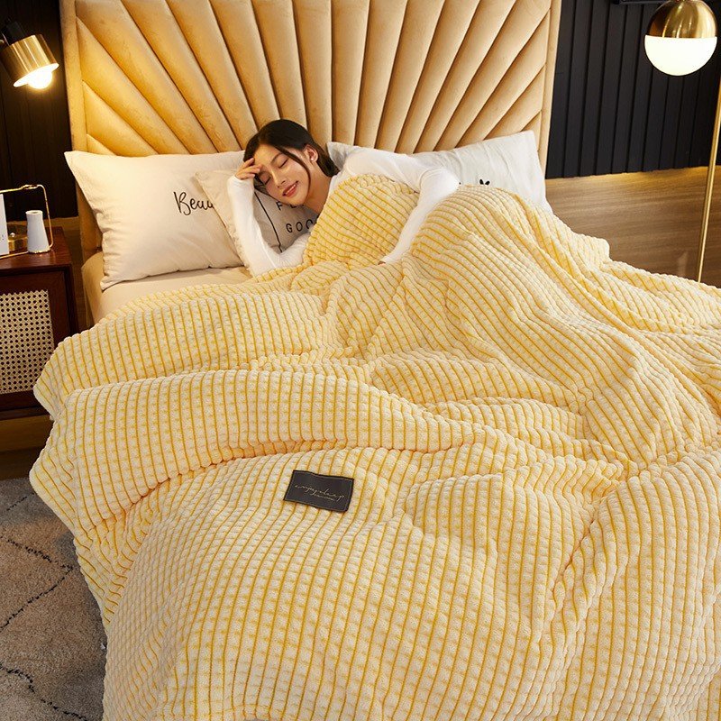 Yellow waffle blanket spread over a double bed; the bed photo shows a larger size than the 100 x 120 cm sold here