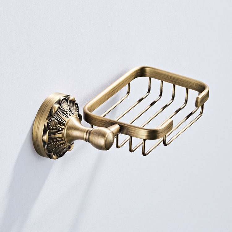 Antique bronze finish soap basket mounted on a wall, seen from the side, basket empty