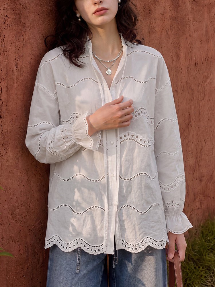 Closer front view of the tie-neck blouse with the button front and wavy eyelet embroidery