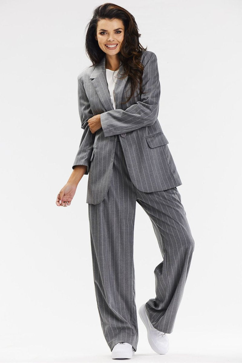 Professional Woman Wearing Wide-Leg Trousers in Office Setting