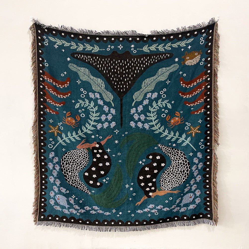 Teal ocean design throw with manta ray, fish and seaweed, hung on a wall